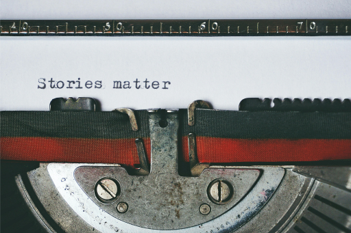Close-up of a typewriter with the words "stories matter" typed.
